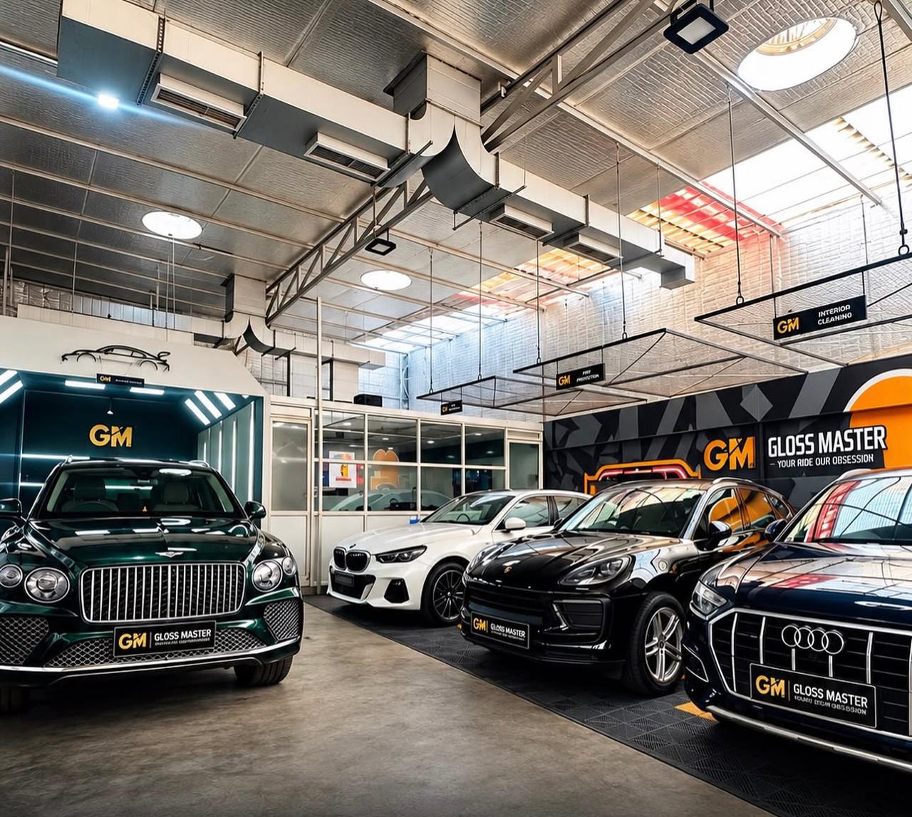Unedited original photograph of Gloss Master studio with several cars