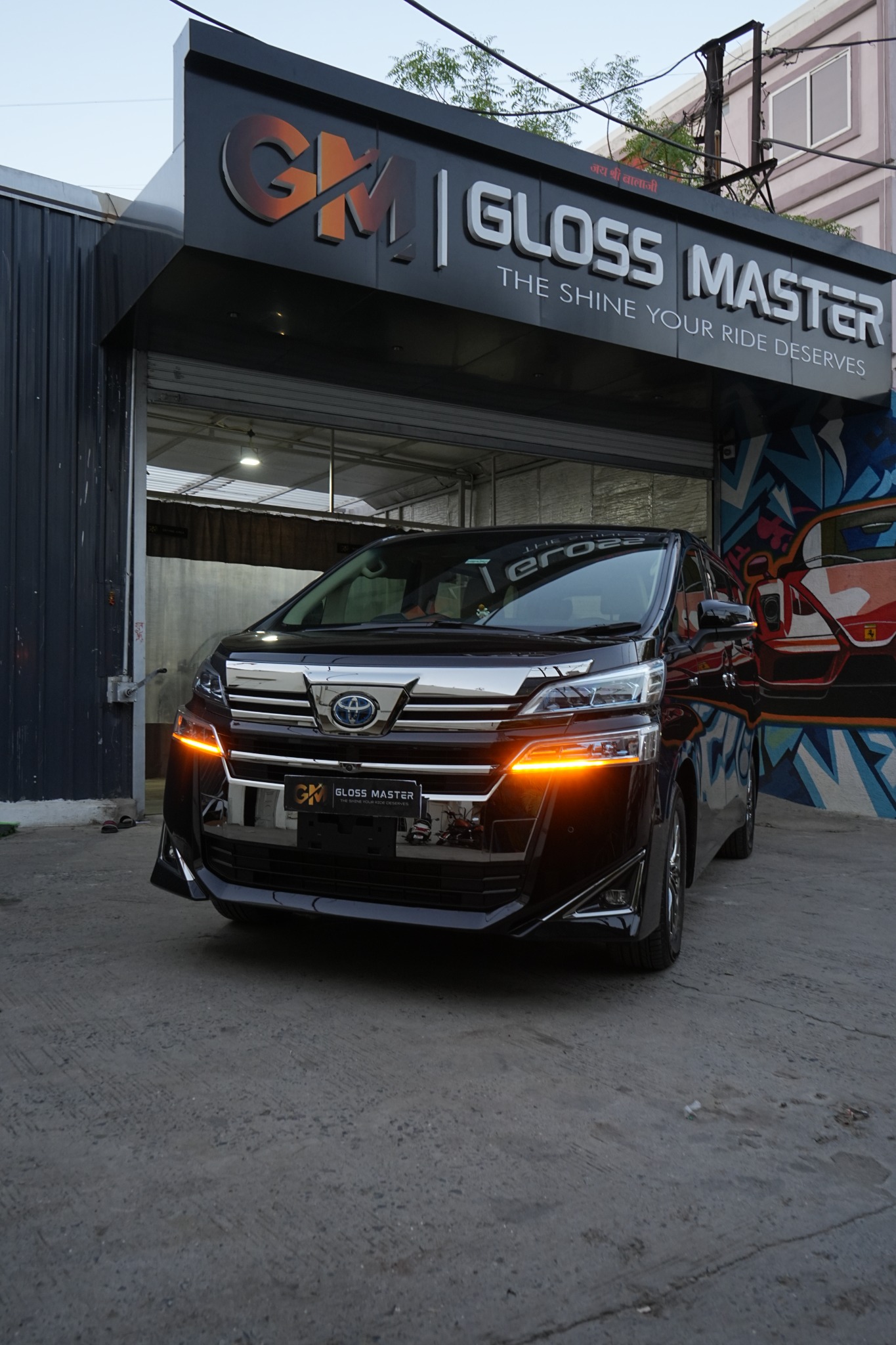 Actual Gloss Master studio exterior with customer vehicle and open entrance
